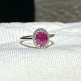 Ring in 18K White Gold with Oval Ruby and Diamond Halo